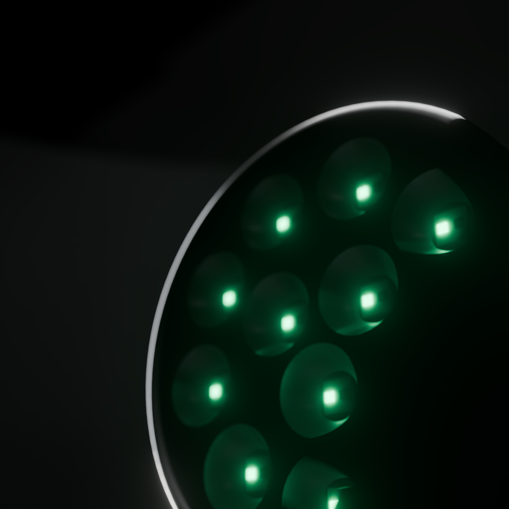 Raking close view of the DRKD Retreat 21 head, its 12 LED wells lit green in polished reflector cups.