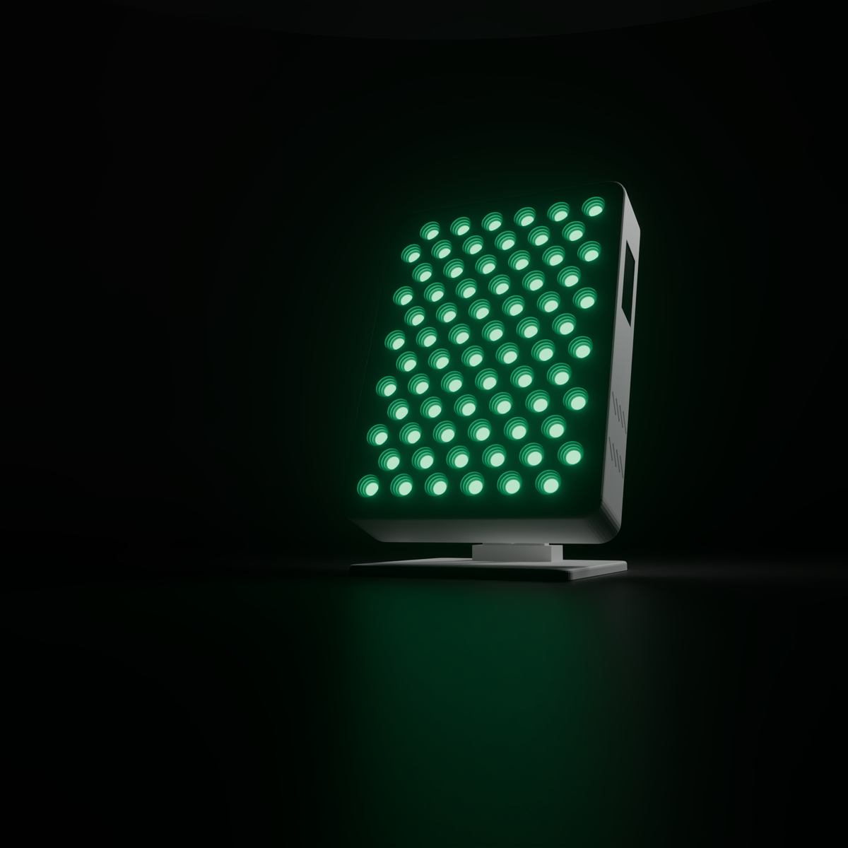 DRKD Retreat 32 lit green in a dark room, its light spilling across the surface it stands on.